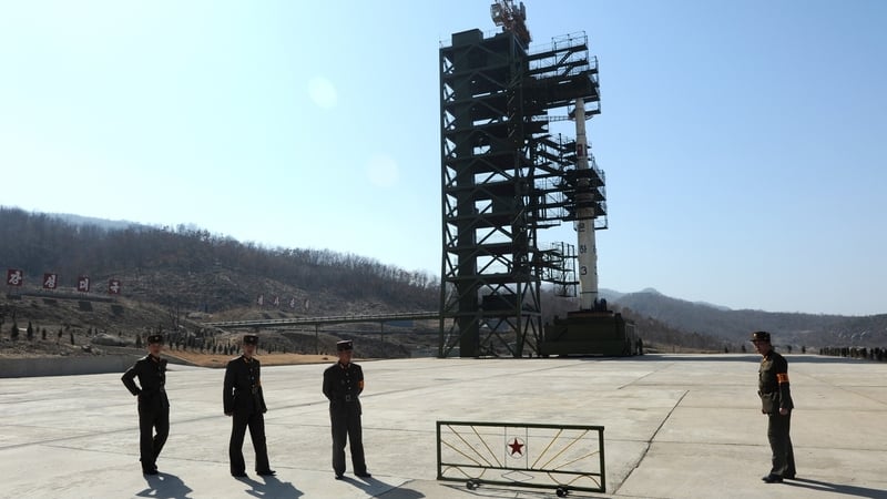 North Korean soldiers guard the Unha-3 rocket