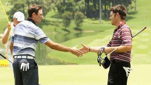 Charl Schwartzel (L) and Louis Oosthuizen on the ninth hole in Kuala Lumpur
