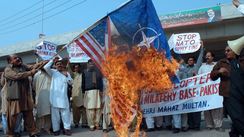 US and NATO flags are burned in the wake of the killings of 24 Pakistani soldiers in November