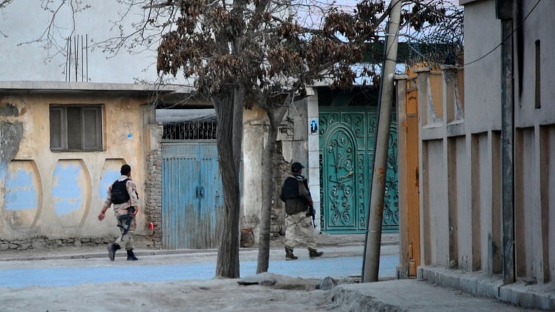 Members of Afghan special forces walk towards the scene of attacks in Kabul