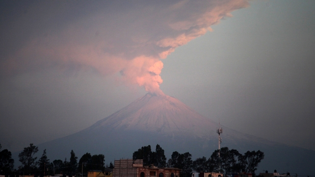 Ash and smoke are spewed from Popocatepetl Volcano as seen from the city of Puebla, Mexico