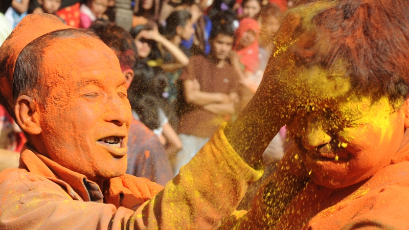 Nepalese revellers smear each other with vermillion powder during The Bisket Jatra Festival on the outskirts of Kathmandu