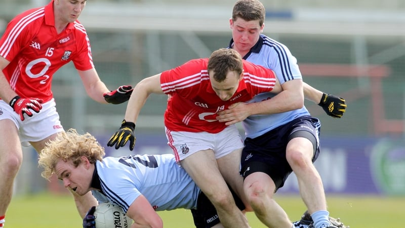 Dublin's Patrick O'Higgins and John Kelly battle for posession with Dublin's Brian O'Driscoll