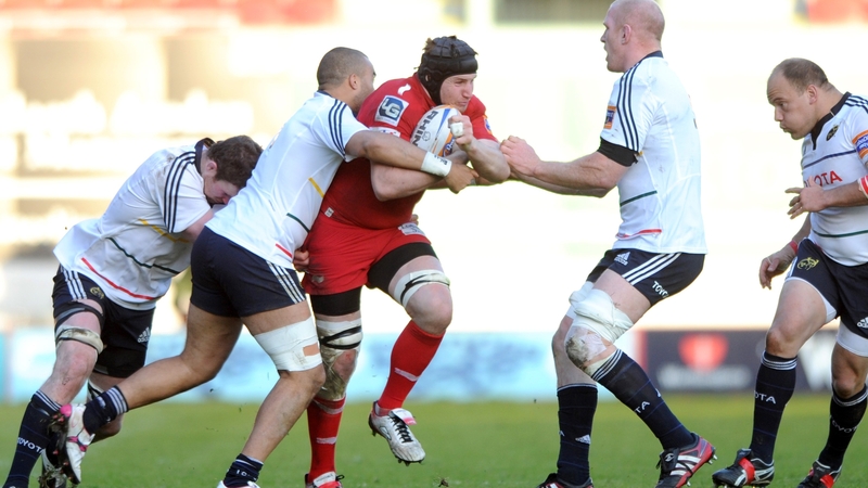 Ben Morgan of Scarlets is tackled by Simon Zebo