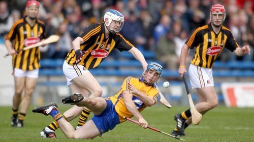 Clare's Patrick O'Connor offloads under pressure from TJ Reid of Kilkenny
