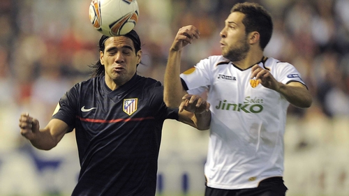 Atletico Madrid's Radamel Falcao gets in ahead of Valencia's Jordi Alba