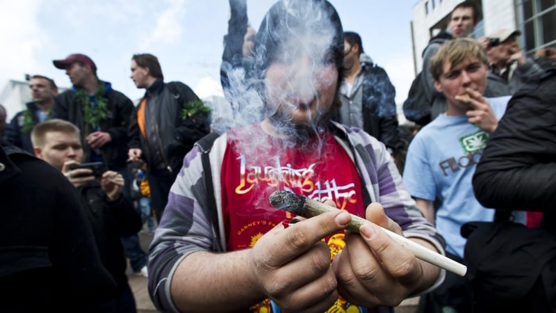 Protesters smoke marijuana during a demonstration against new government legislation calling for the creation of a 'cannabis card'