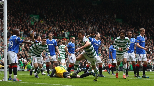 Charlie Mulgrew (centre) opens the scoring for Celtic against Rangers