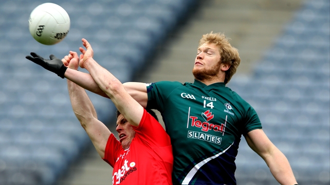 Tyrone's Conor Gormley and Tomas O'Connor of Kildare compete for the dropping ball