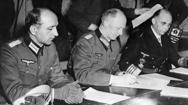 German army chief Alfred Jodl signing an unconditional surrender on 7 May 1945