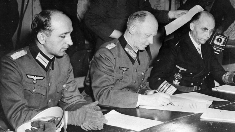 German army chief Alfred Jodl signing an unconditional surrender on 7 May 1945