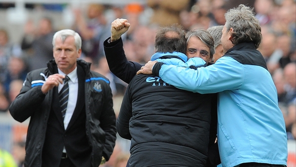 Roberto Mancini is congratulated by management staff as Alan Pardew looks on. Mancini has called for calm from his players ahead of their final game