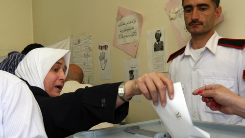 A Syrian woman casts her vote in the country's parliamentary election
