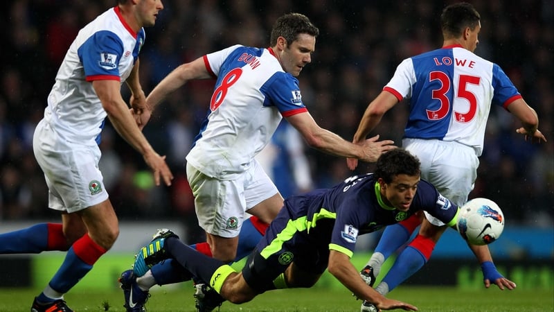 Wigan's Franco Di Santo takes a tumble under pressure from David Dunn