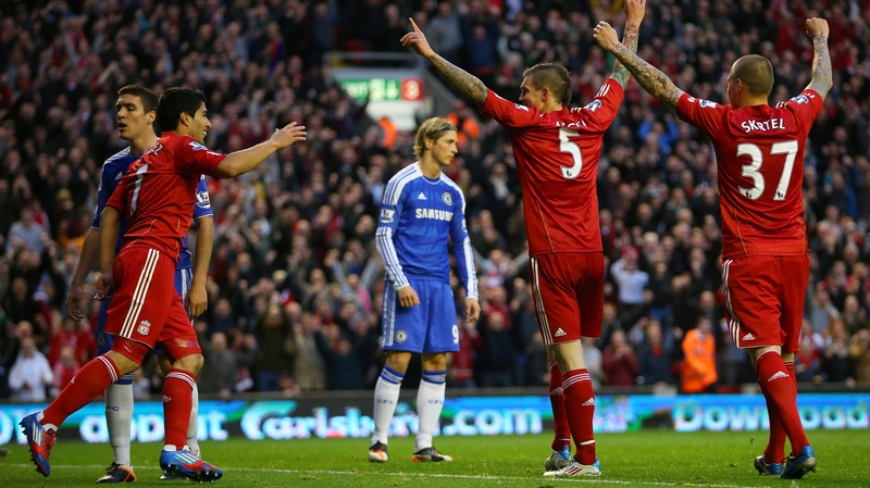 Former Liverpool striker Fernando Torres looks dejected as Reds players celebrate at Anfield