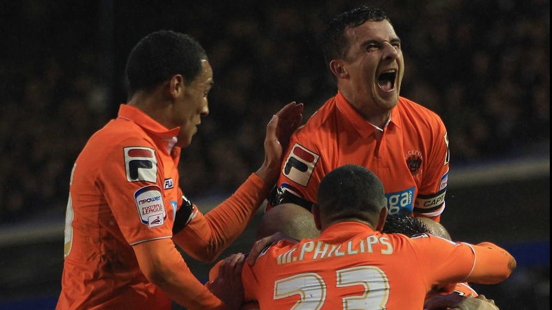 Blackpool players mob Stephen Dobie after his crucial opener