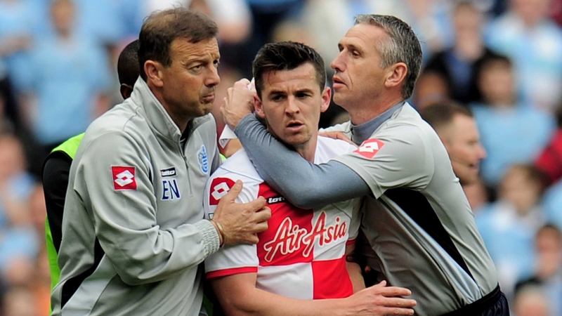 QPR backroom staff escort Joey Barton from the pitch