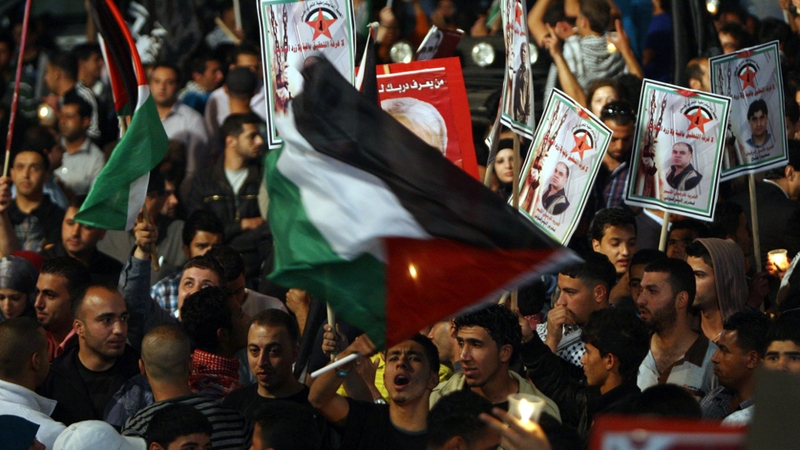 Palestinians celebrate in Ramallah after news of the deal emerged