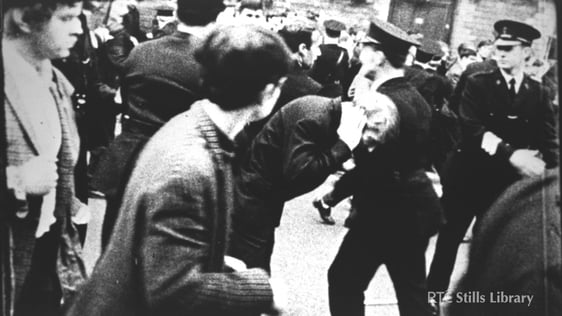 RUC men and civilians on a Derry street during the riots.

© RTÉ Stills Library 0130/058