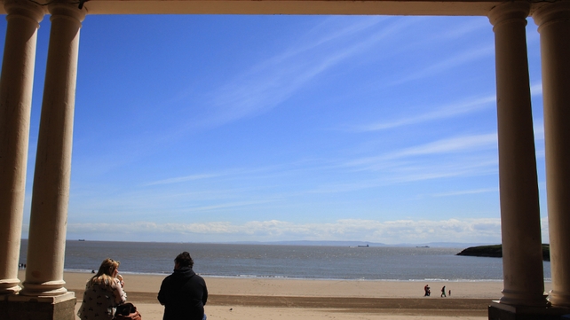 People enjoy the good weather at the beach in Barry, Wales