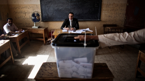 Egyptian electoral officials monitor the voting process at a polling station in the village of Namul, north of Cairo