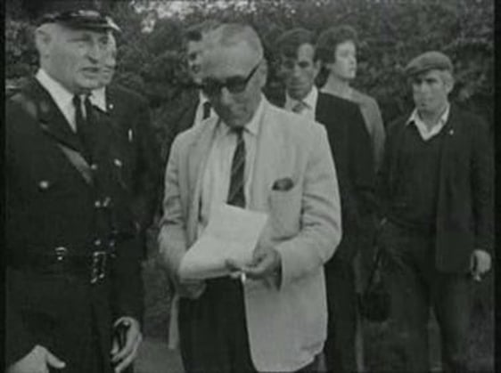 Gary Lennon is served with a notice from the RUC not to enter Market Square.
