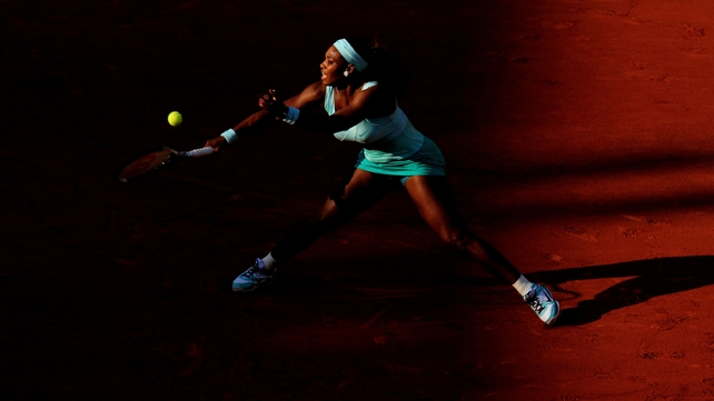 Serena Williams plays a forehand in her women's singles first round against Virginie Razzano in the French Open
