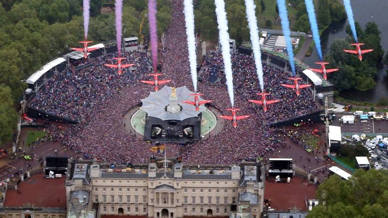 The Red Arrows fly over in formation over Buckingham Palace