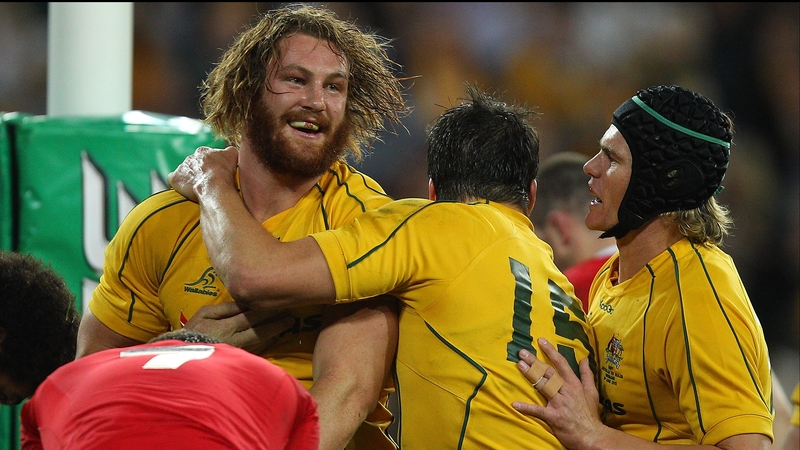 Australia's Scott Higginbotham celebrates with team mates after scoring his first Test try