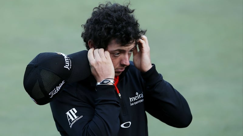 Rory McIlroy holds his head in his hands after carding a round of 77 in San Francisco
