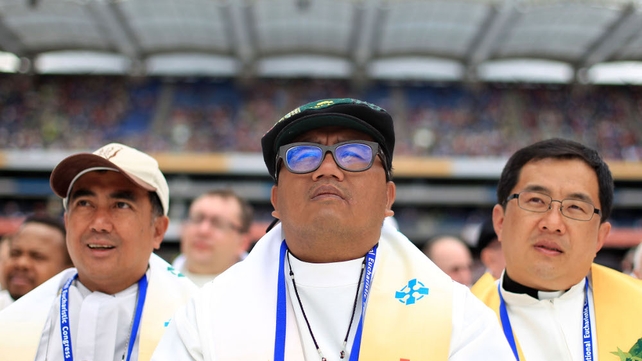 Priests watch events at the closing ceremony of the Congress in Croke Park
