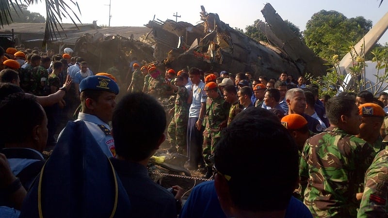 Emergency personnel look through the rubble after the crash