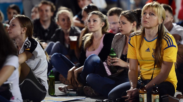 Fans outside the arena watching a giant screen in the fan zone in Donetsk