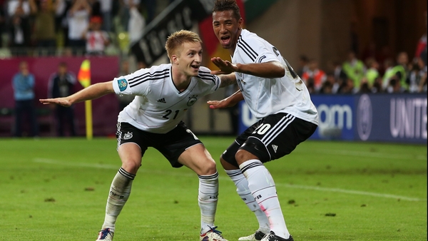 Marco Reus celebrates with Jerome Boateng after scoring Germany's fourth