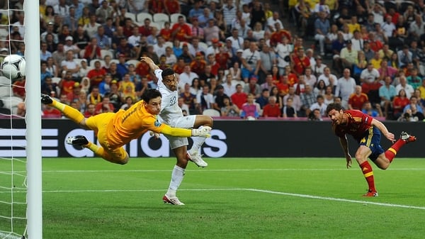 Xabi Alonso heads home the opener for Spain
