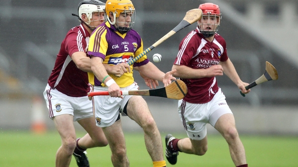 Wexford's David Redmond with Paul Greville of Westmeath