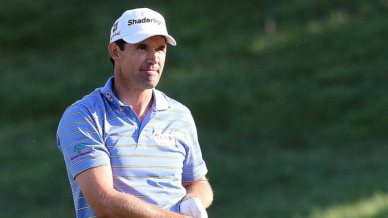 Padraig Harrington watches an approach shot as it lands on the 18th green