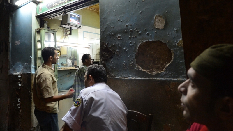 Egyptians watch the first televised address of President Mursi in a Cairo café