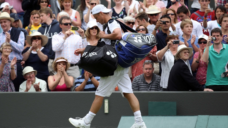Lleyton Hewitt walks of court after his straight sets defeat by Jo-Wilfried Tsonga