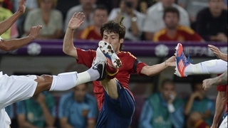 Spain's David Silva battles for possession with two Portuguese players