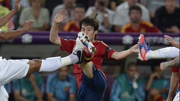Spain's David Silva battles for possession with two Portuguese players