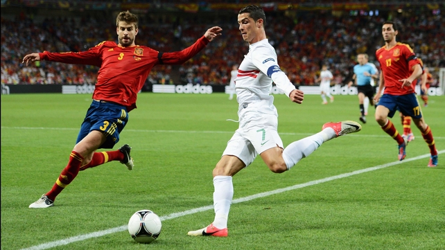 Ronaldo gets in a cross despite the attentions of Spanish defender Gerard Pique