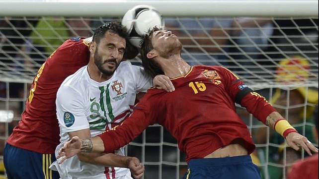 Portugal's Hugo Almeida is caught in a Pique-Sergio Ramos sandwich