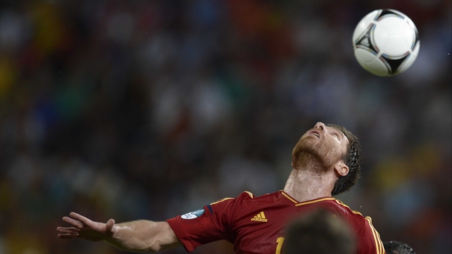 Xabi Alonso attempts to head the ball