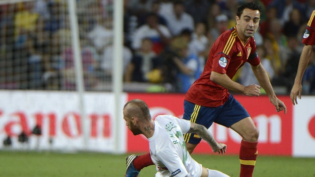 Spain's Xavi skips past Portugal midfielder Raul Meireles
