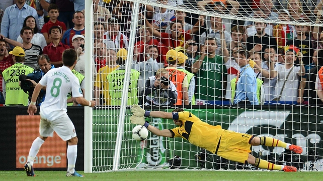 Spanish goalkeeper Iker Casillas saves from Joao Moutinho