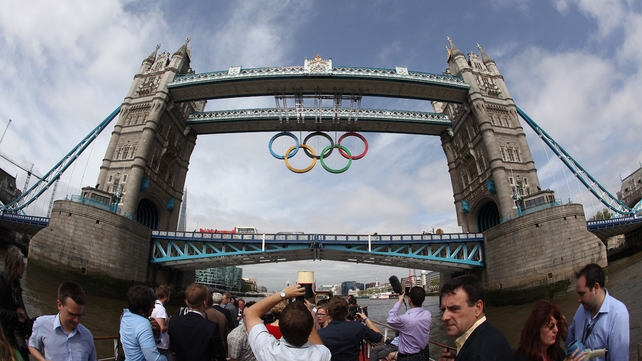 The Olympic rings are lowered from Tower Bridge in London