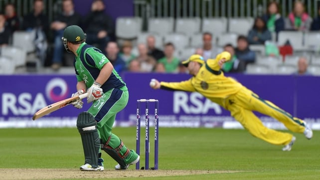 Ireland cricketer Paul Stirling looks on as Australia's Michael Clarke takes a diving catch in their one-day international in Belfast