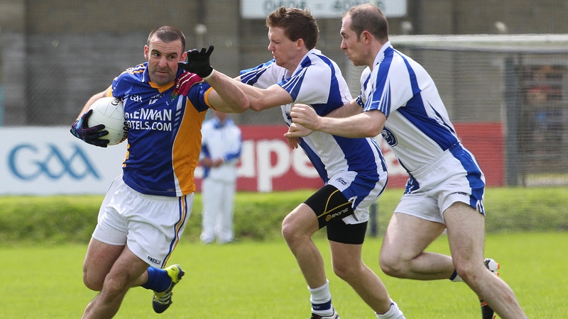 Daragh O'Sullivan of Wicklow holds off Cillian O'Keeffe and Shane Briggs of Waterford