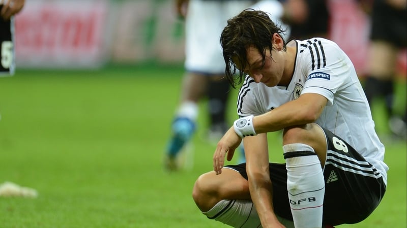 Mesut Oezil reacts to Germany's exit after their 2-1 loss to Italy